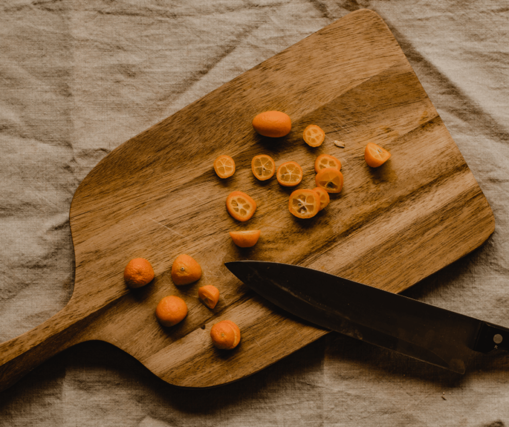 chopping board with fruit and knife