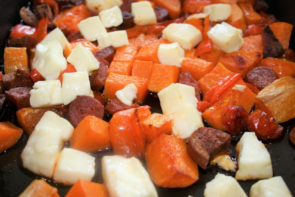 summer pasta ingredients of vegtables, chorizo, and halloumi in roasting tin