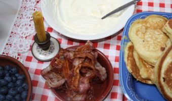 family breakfast with bacon, blueberries and pancakes